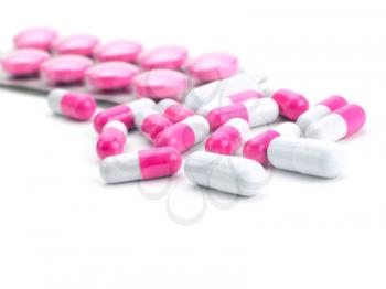vitamins, pills and tablets on white