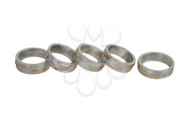 Closeup of five handiwork rings on a white background. 
