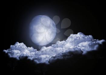 The full moon in clouds in the night sky