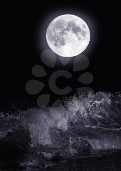 The full moon over the sea at night
