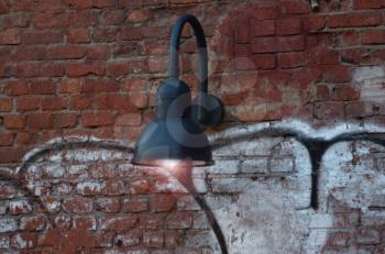 Lantern hanging on a brick wall