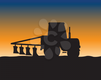 Silhouette of the tractor with plow on background of the field