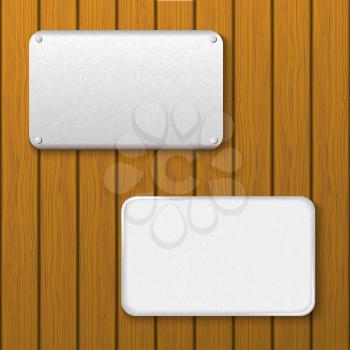 Two metal plates on a wooden wall