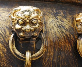 Closeup ancient bronze lions as a handle of vat in Forbidden City