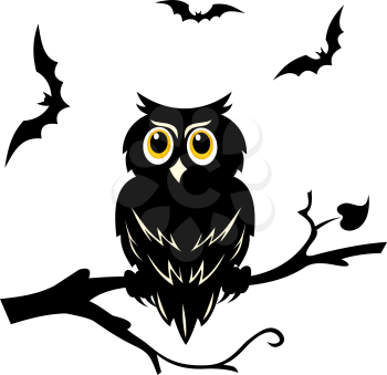 Black halloween owl on the branch of tree