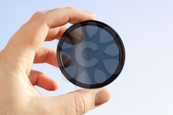 Royalty Free Photo of a Person Holding an Optical Filter