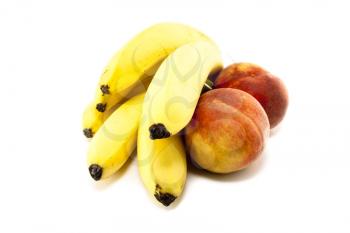 Fresh bananas and peaches on white background