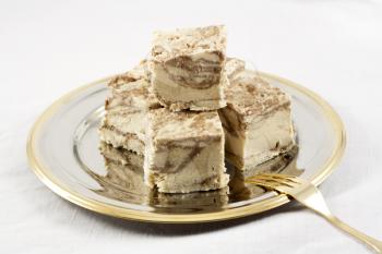 Delicious Halva served in silver-golden dish on white table