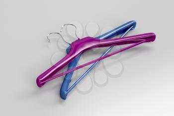 Purple and blue coat hangers on gray background