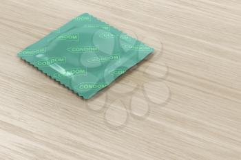 Condom packaging on wood background