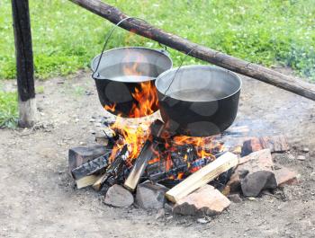 Royalty Free Photo of Two Pots Over a Campfire