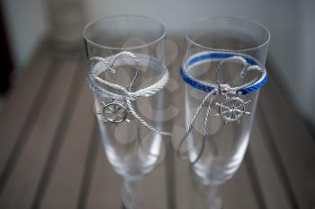 Wedding glasses with two anchors on a yacht