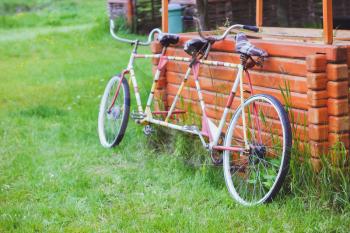 Bicycles for two passengers, the tandem on the green grass