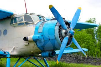 Old retro airplane on green grass field