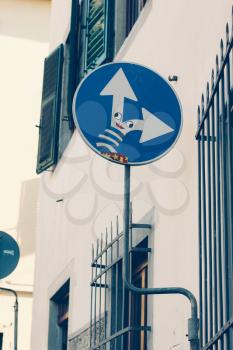 Road signs in Florence, Italy. The arrows in the form of spring