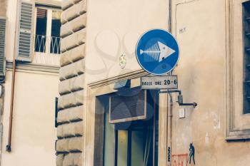Road signs in Florence, Italy. The arrow in the shape of a fish