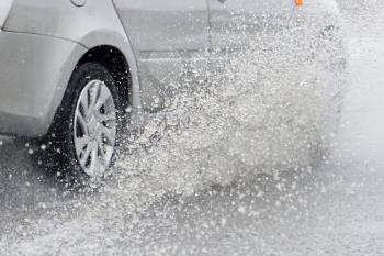 Splashing water from under the car wheels
