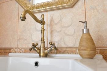 Beautiful bronze faucet in the sink in the bathroom.