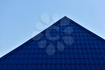 The roof is blue on blue sky background