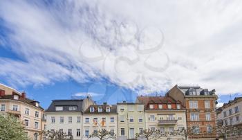 Beautiful exterior of the upper floors and roofs of residential buildings against the sky in Europe, Germany. Roofs of German houses against the sky