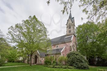 Beautiful and old Evangelical church surrounded by green bushes and trees in the European country, Baden Baden