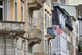 American flag mounted on the balcony of a residential building in Europe, Germany.