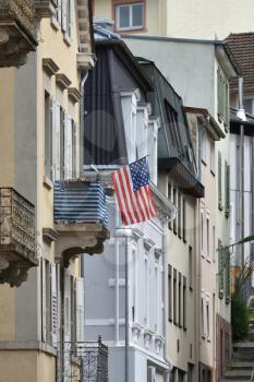 American flag mounted on the balcony of a residential building in Europe, Germany.