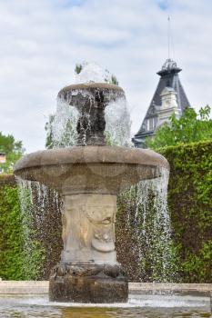 Antique water fountain in a public park of a European city