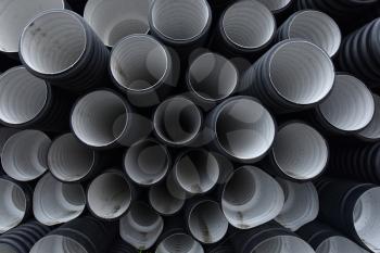 New black-and-white plastic pipes for sewerage system.