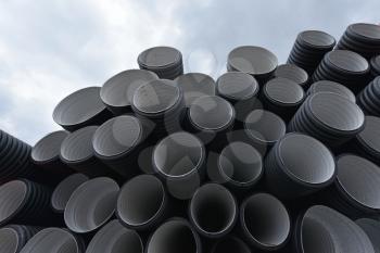New black-and-white plastic pipes for sewerage system.