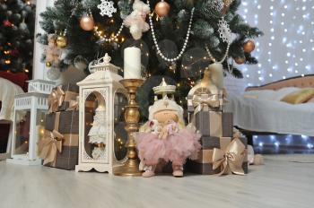 Children's Christmas gifts stand under the Christmas tree, gifts and soft cute doll
