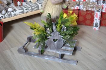 Small wooden sled with branches of pine needles for decor for Christmas