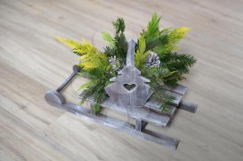 Small wooden sled with branches of pine needles for decor for Christmas