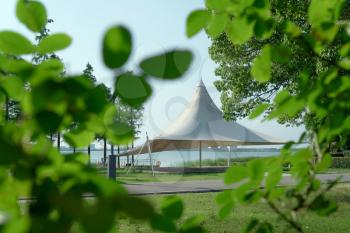 A sailboat tent by the lake, public park scenery. Photo in the public park.