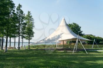 A sailboat tent by the lake, public park scenery. Photo in the public park.