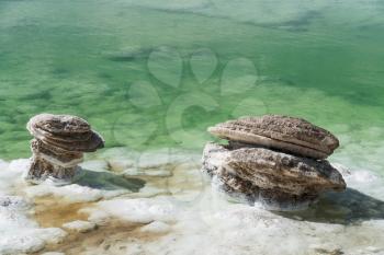 Salt stones by the green saline lake. Photo in Qinghai, China.