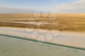 Salt lake with wide flatlands background. Photo in Qinghai, China.