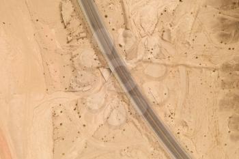 Dryness land with erosion terrain with highway crossing. Photo in western China