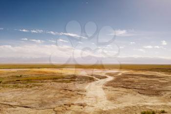 Wide deserted land with curve path. Photo in Qinghai, China.