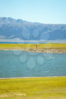 Road and lighthouses on the lake. Shot in Sayram Lake, Xinjiang, China.