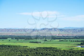 Grassland and mountains in a sunny day. Shot in Xinjiang, China.