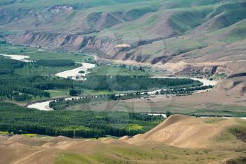 Meandering river and mountains in a sunny day. Shot in Xinjiang, China.