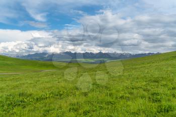 Grassland and mountains in a sunny day. Shot in Xinjiang, China.