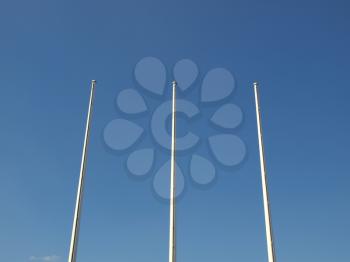 Flagpole flagstaff mast over a blue sky background