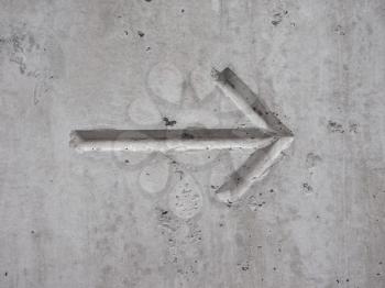 left to right direction arrow on concrete wall background