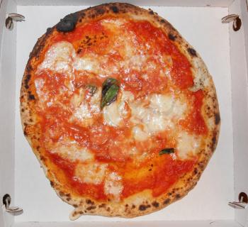 Italian Pizza Margherita (Margarita) with tomato and Mozzarella cheese in a cardboard box for take away