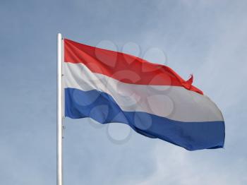 Flag of Netherlands over a blue sky