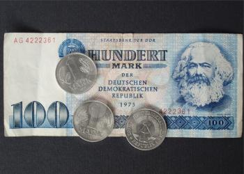 100 Mark banknote from the DDR (East Germany) with Karl Marx with 1 Mark coin - Note: no more in use since german reunification in 1989