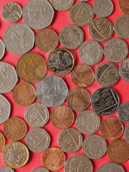Pound coins money (GBP), currency of United Kingdom, over red background