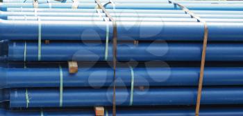 large blue pipes being transported on a truck